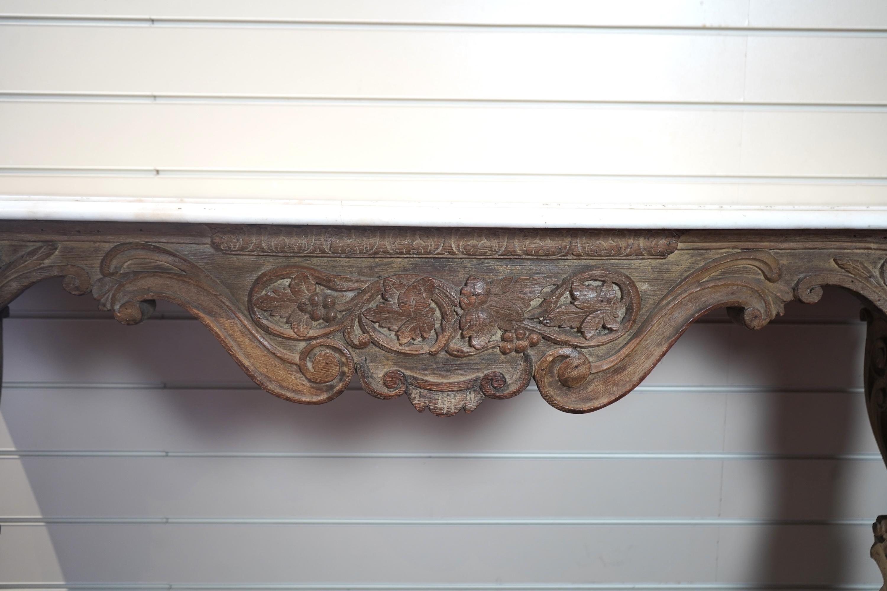 A 19th century Baroque style marble topped limed oak serpentine console table